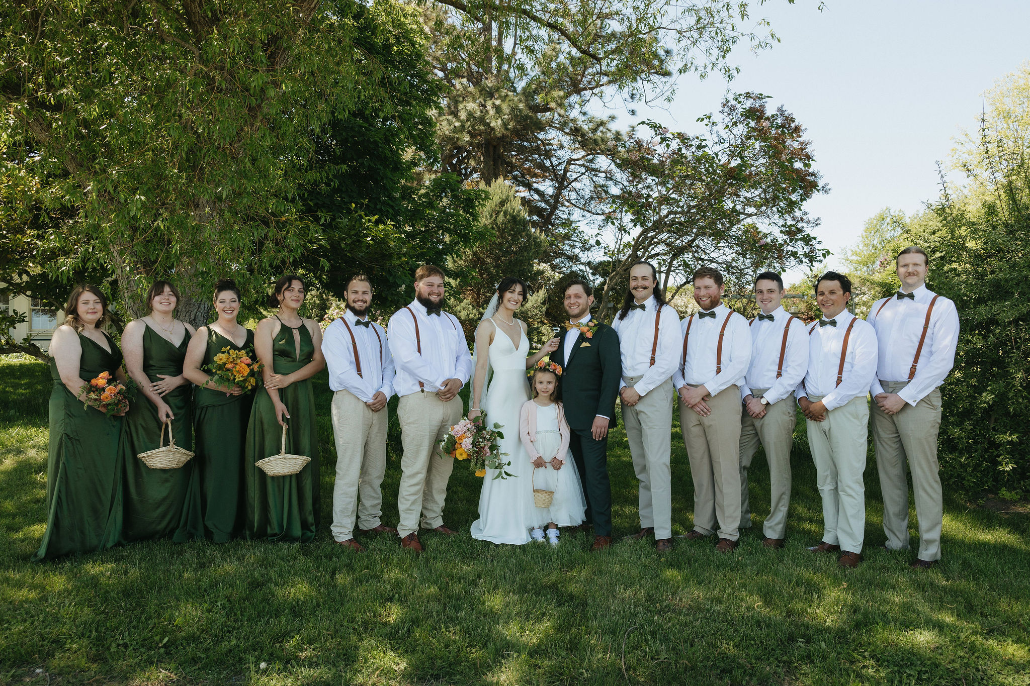 Bridal party smiling with bride and groom