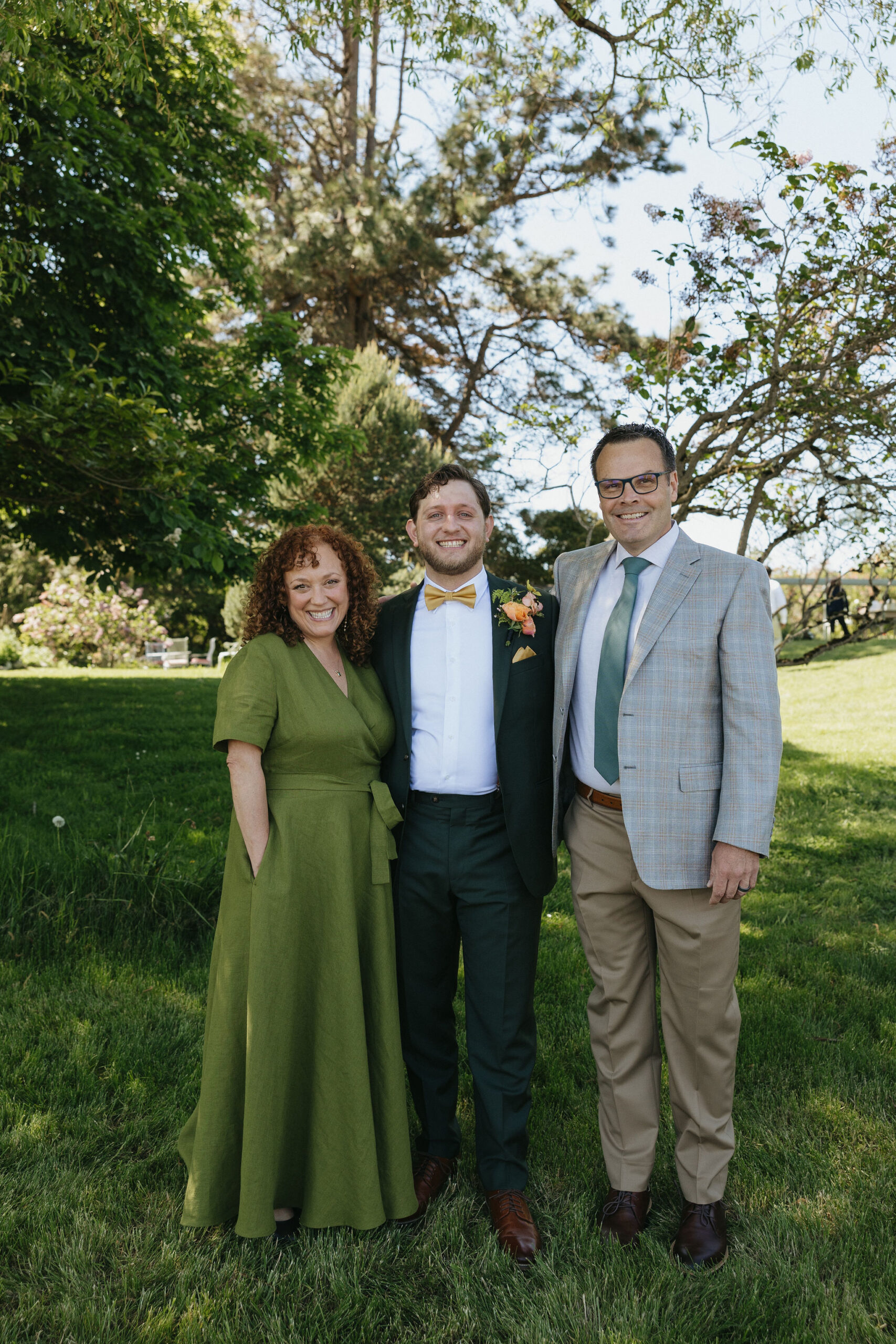 Groom posing and smiling with family at Whidbey Island wedding venue