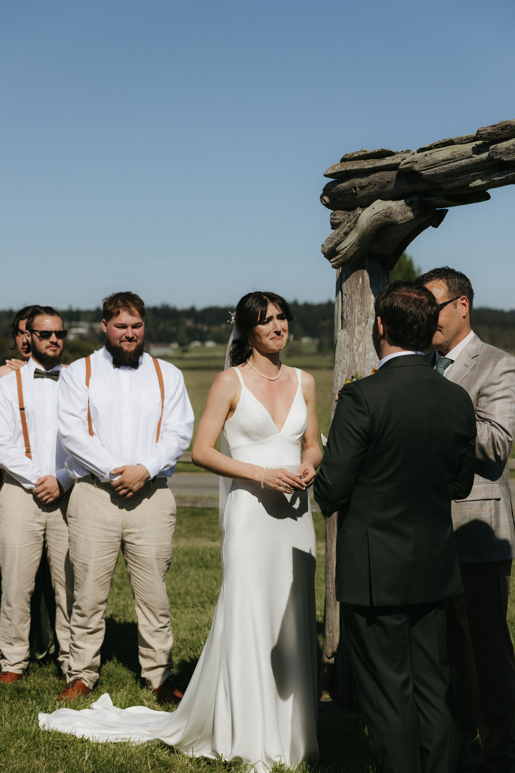 Bride tearing up as groom reads his vows