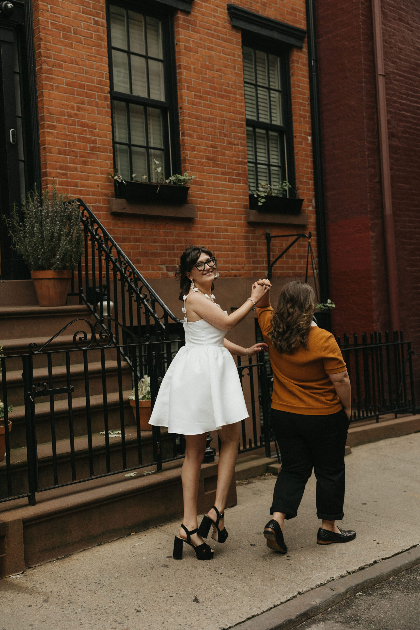 Newly engaged couple walking the streets of Cornelia Street in New York