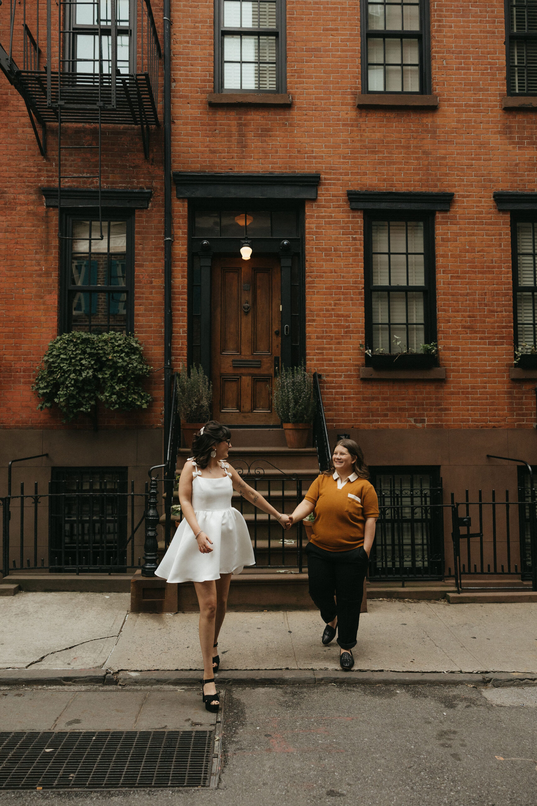 Newly engaged couple walking the streets of Cornelia Street in New York