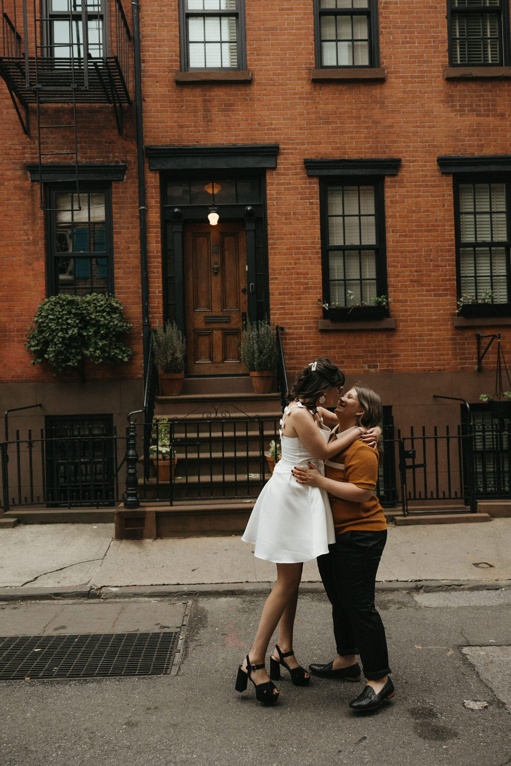 Newly engaged couple walking the streets of Cornelia Street in New York