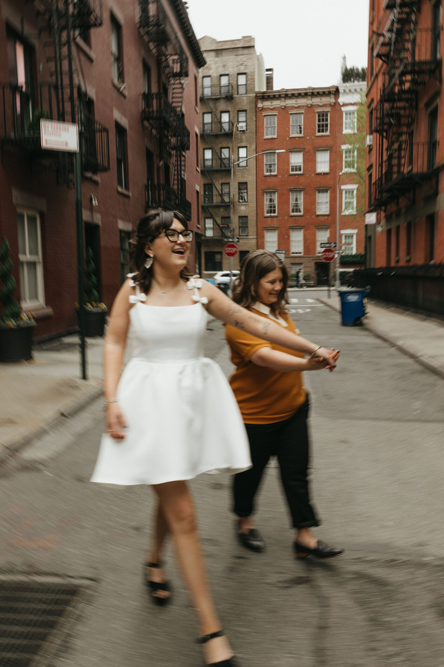 Newly engaged couple walking the streets of Cornelia Street in New York