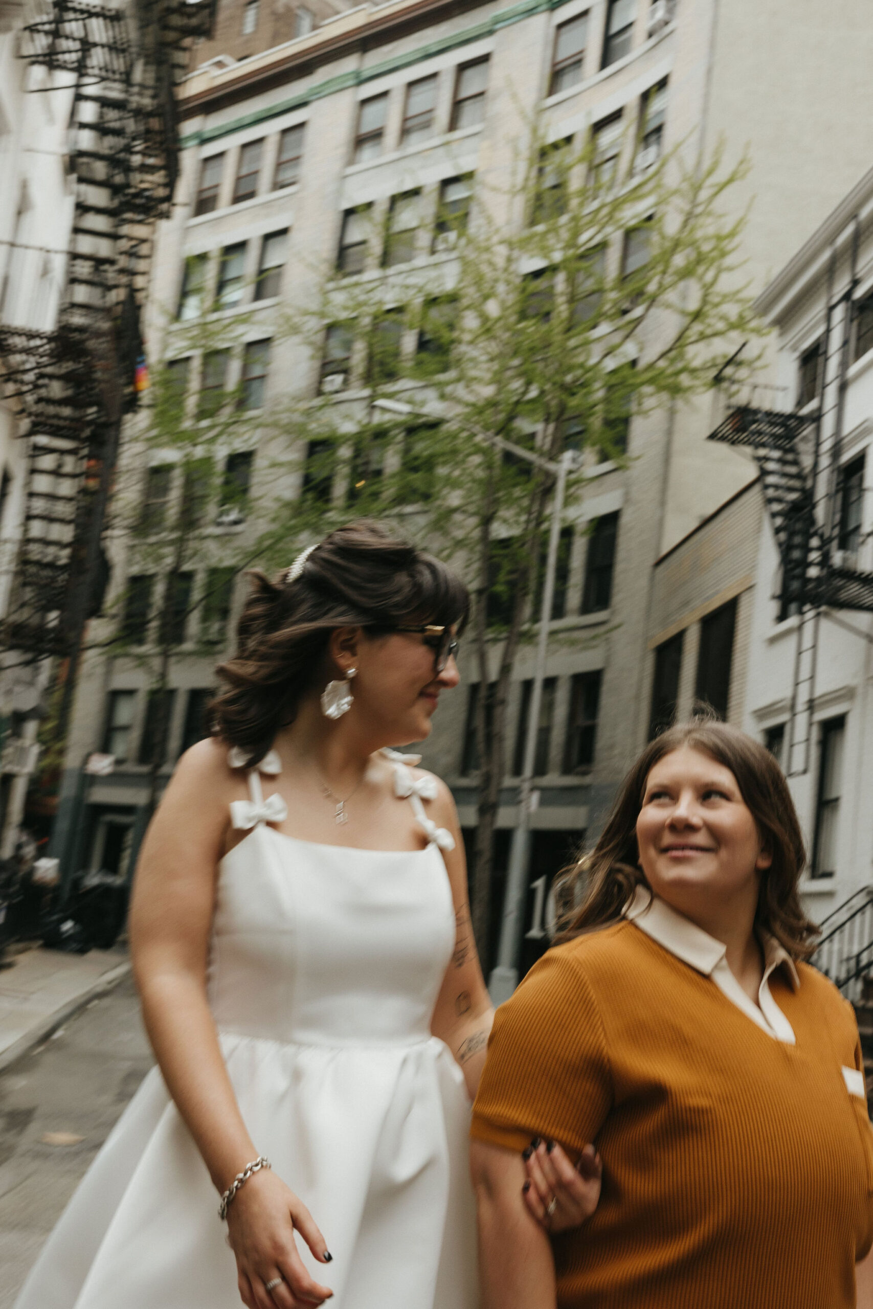 Newly engaged couple walking the streets of Cornelia Street in New York for their personalized engagement photography