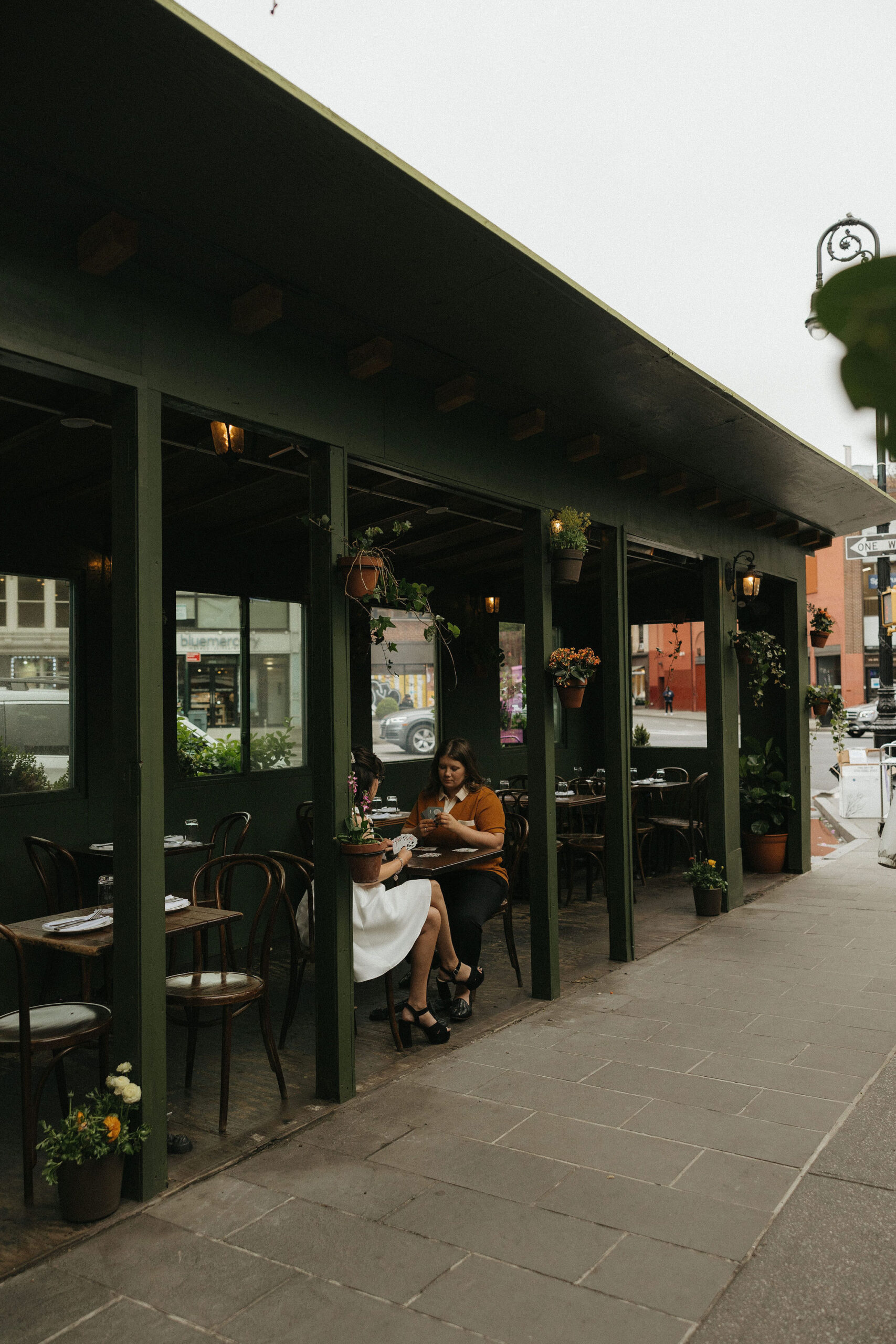 Newly engaged couple playing cards at Olio E Più in New York