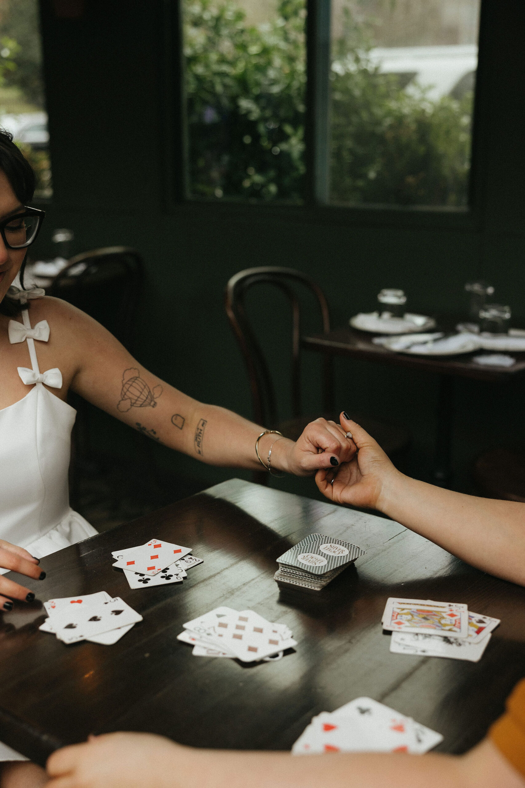 Newly engaged couple playing cards at Olio E Più in New York