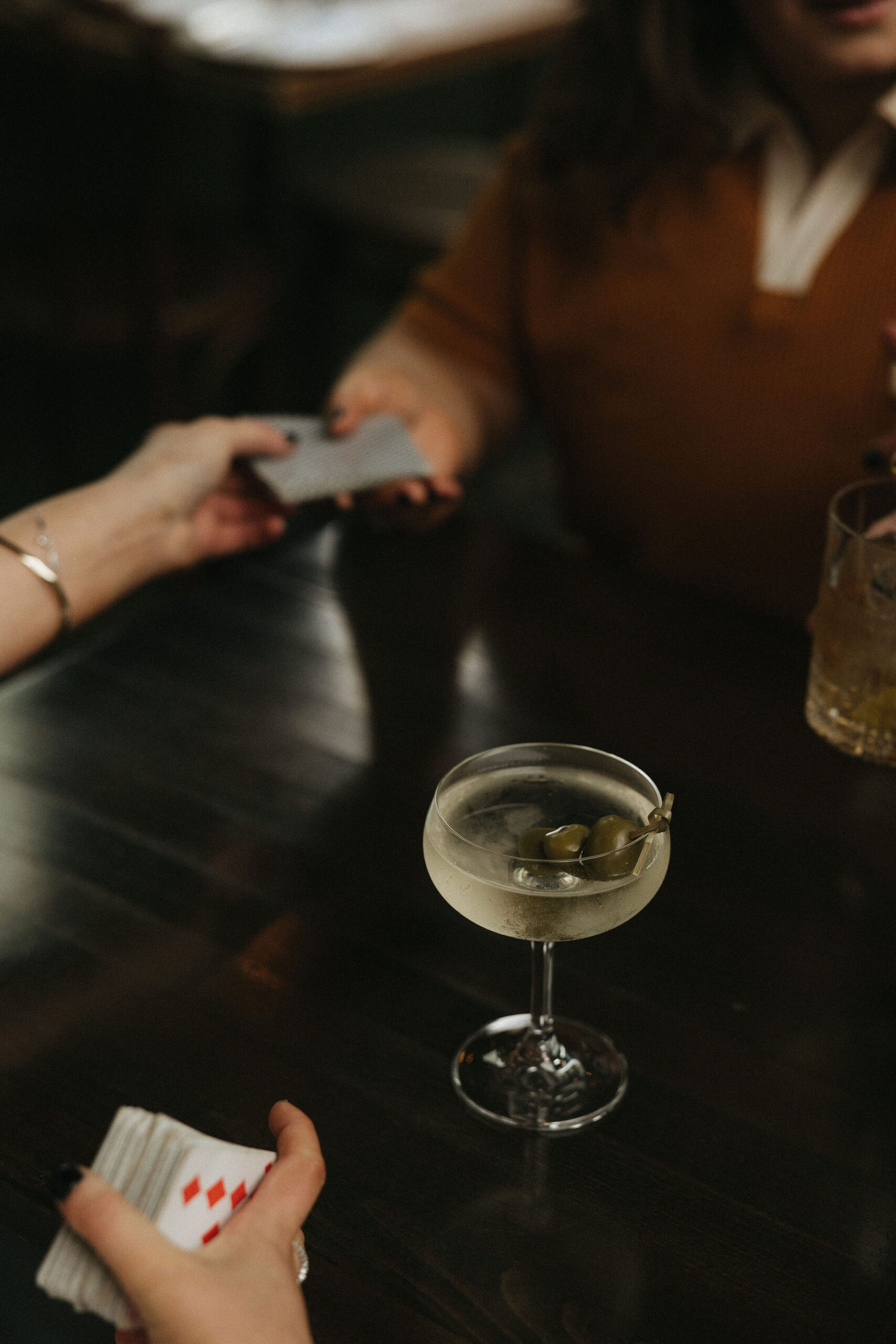 Newly engaged couple playing cards at Olio E Più in New York