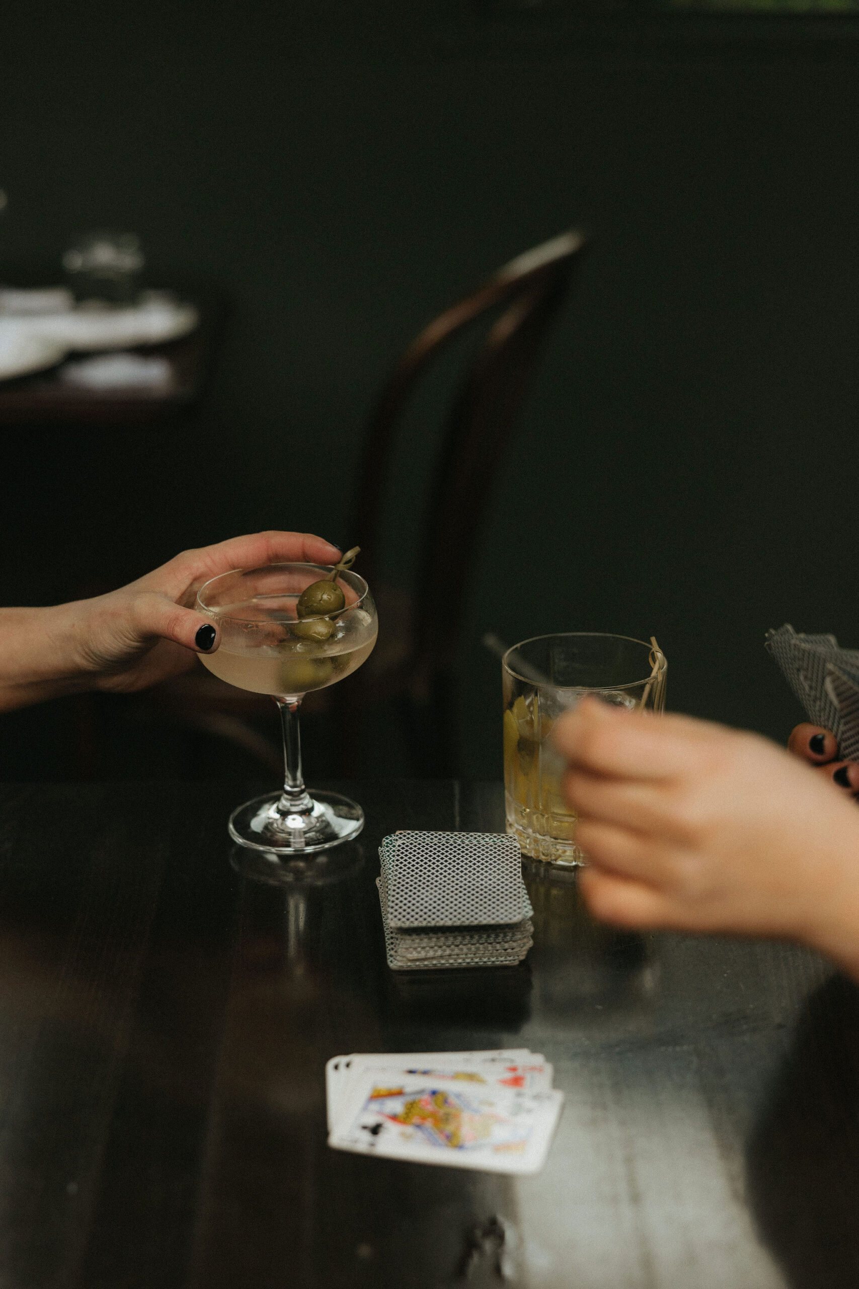 Newly engaged couple playing cards and drinking at Olio E Più in New York