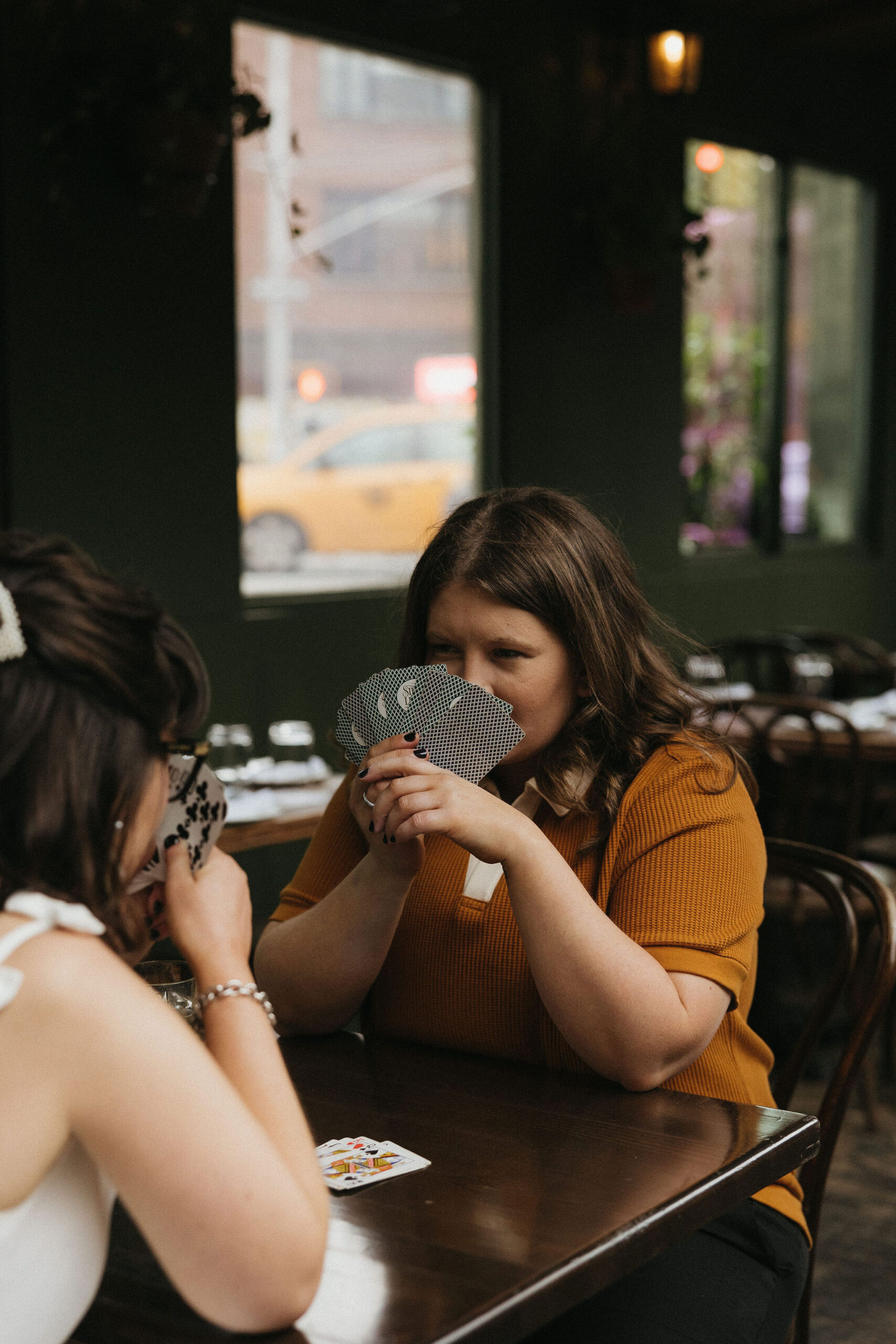 Newly engaged couple playing cards at Olio E Più in New York