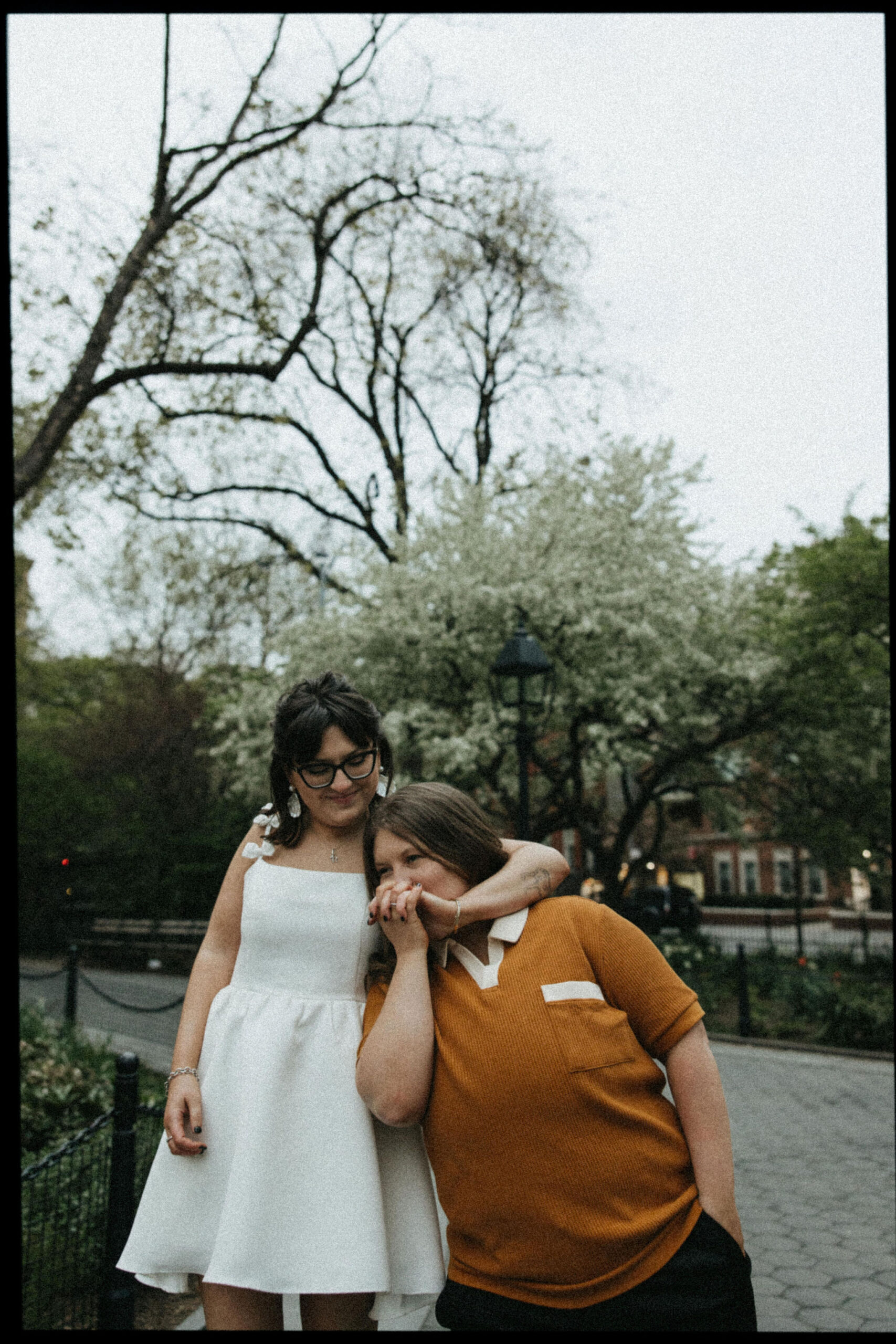 Newly engaged couple holding one another in the streets of New York