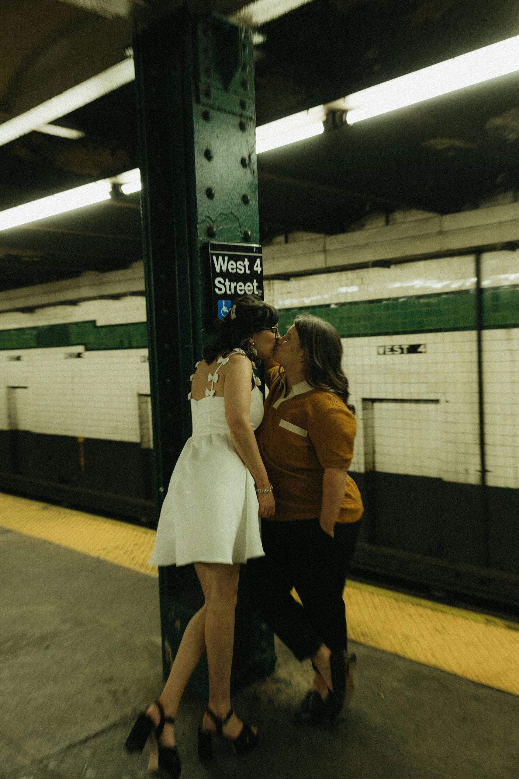 Newly engaged couple kissing in the New York subways