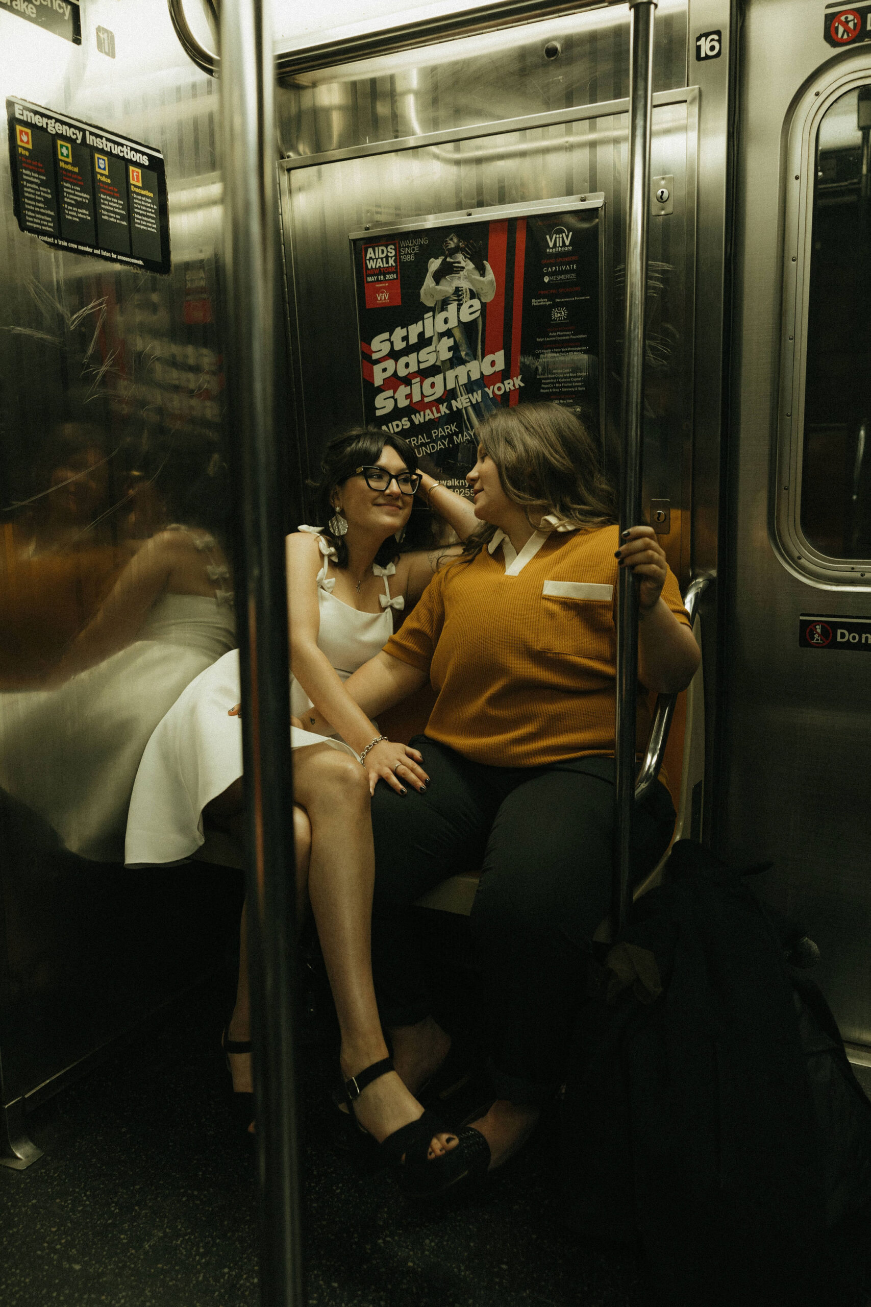 Newly engaged couple sitting in the New York subways for their personalized engagement photography