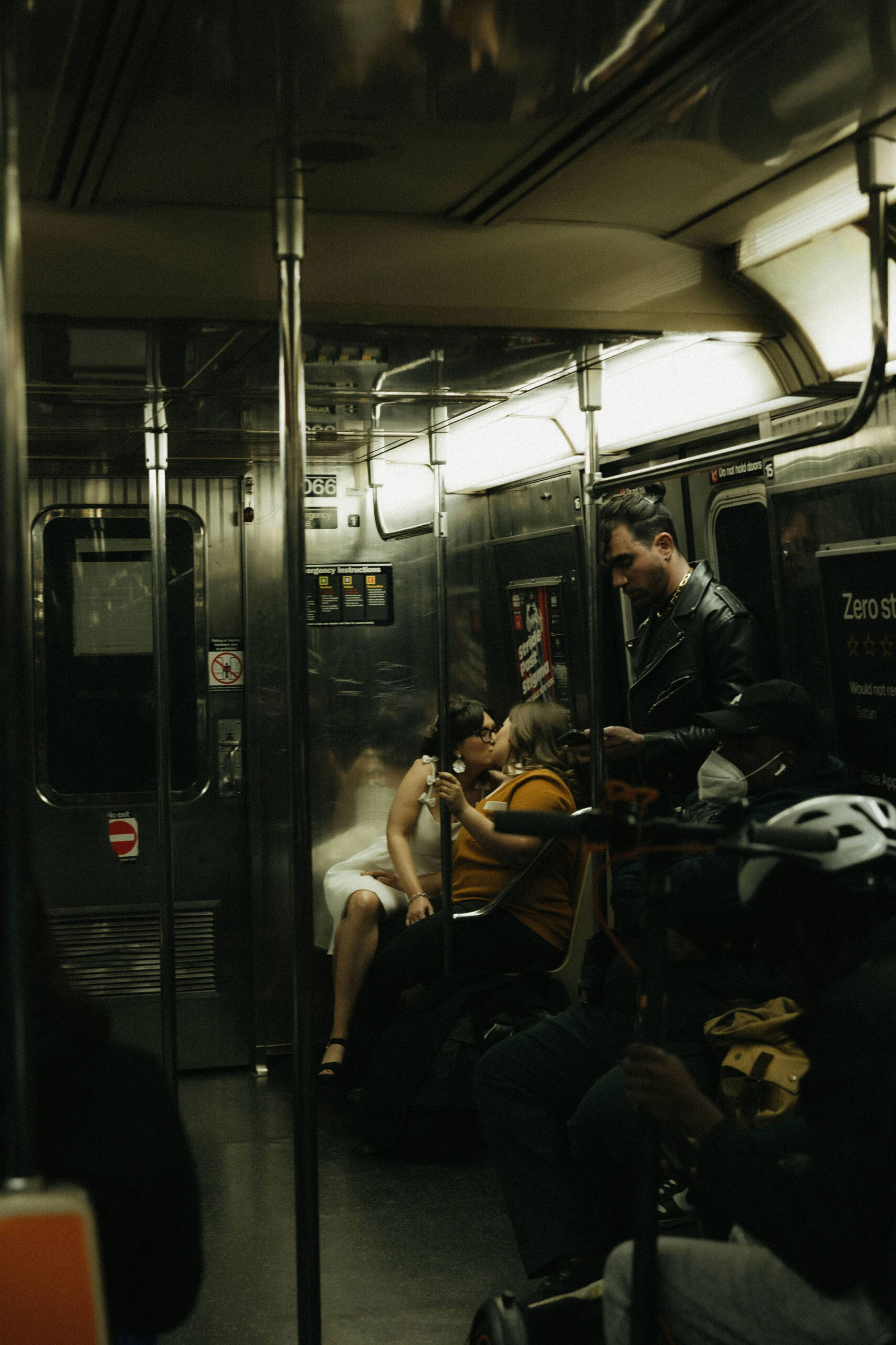 Newly engaged couple kissing in the New York subways for their personalized engagement photography