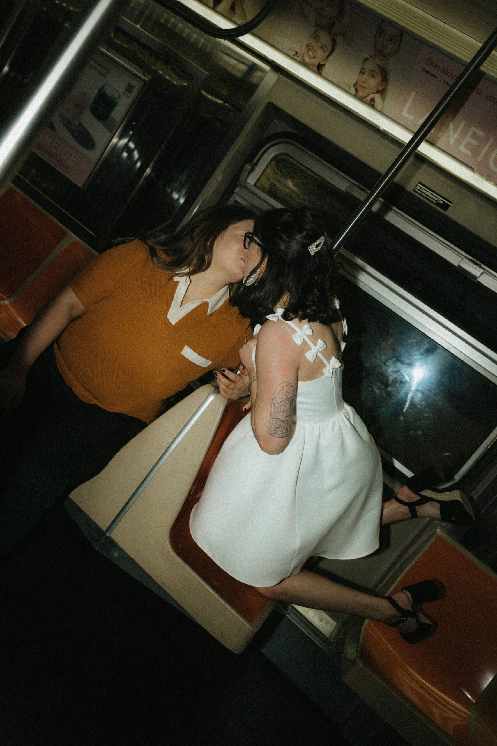 Newly engaged couple kissing in the New York subways for their personalized engagement photography