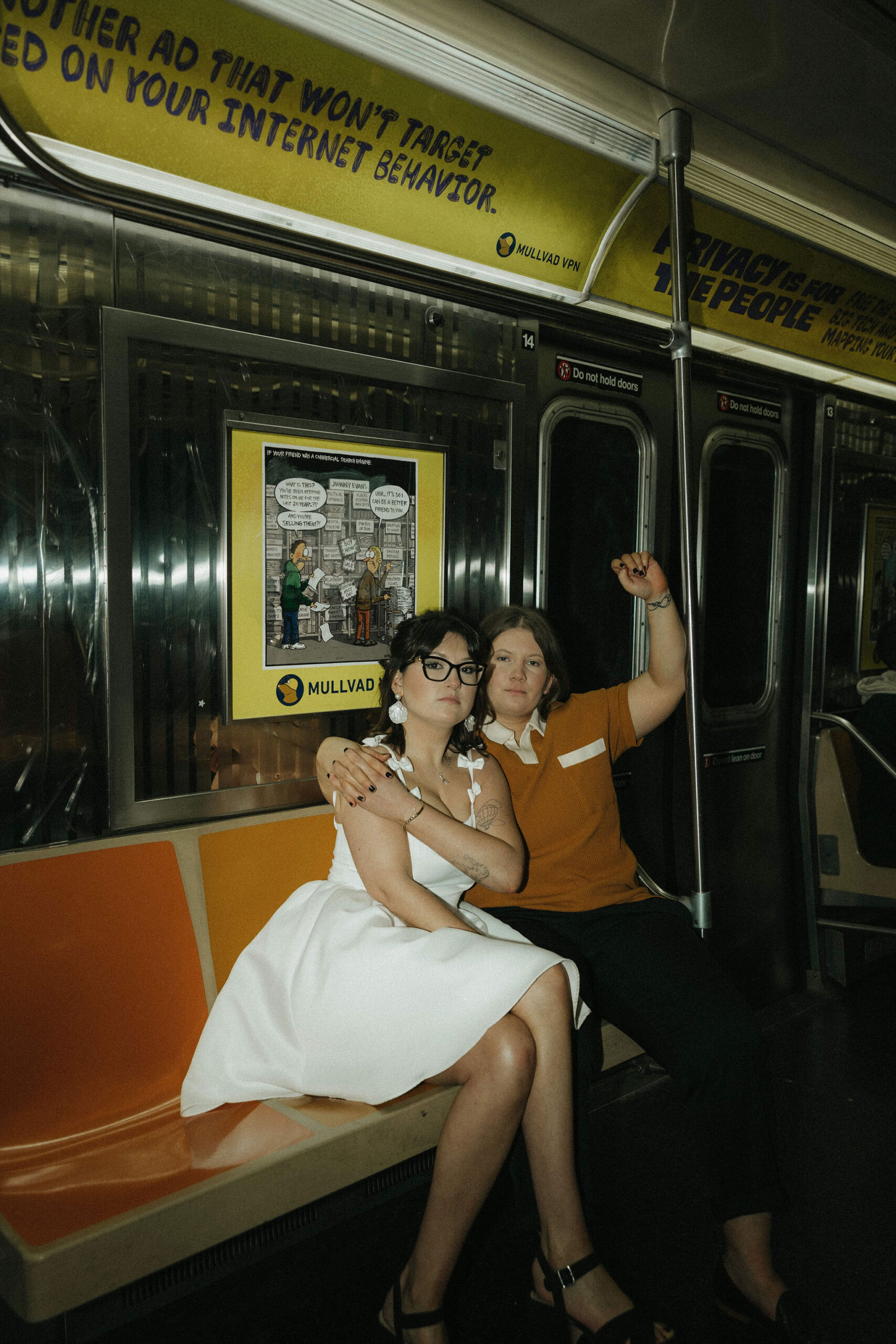 Newly engaged couple sitting in the New York subways for their personalized engagement photography