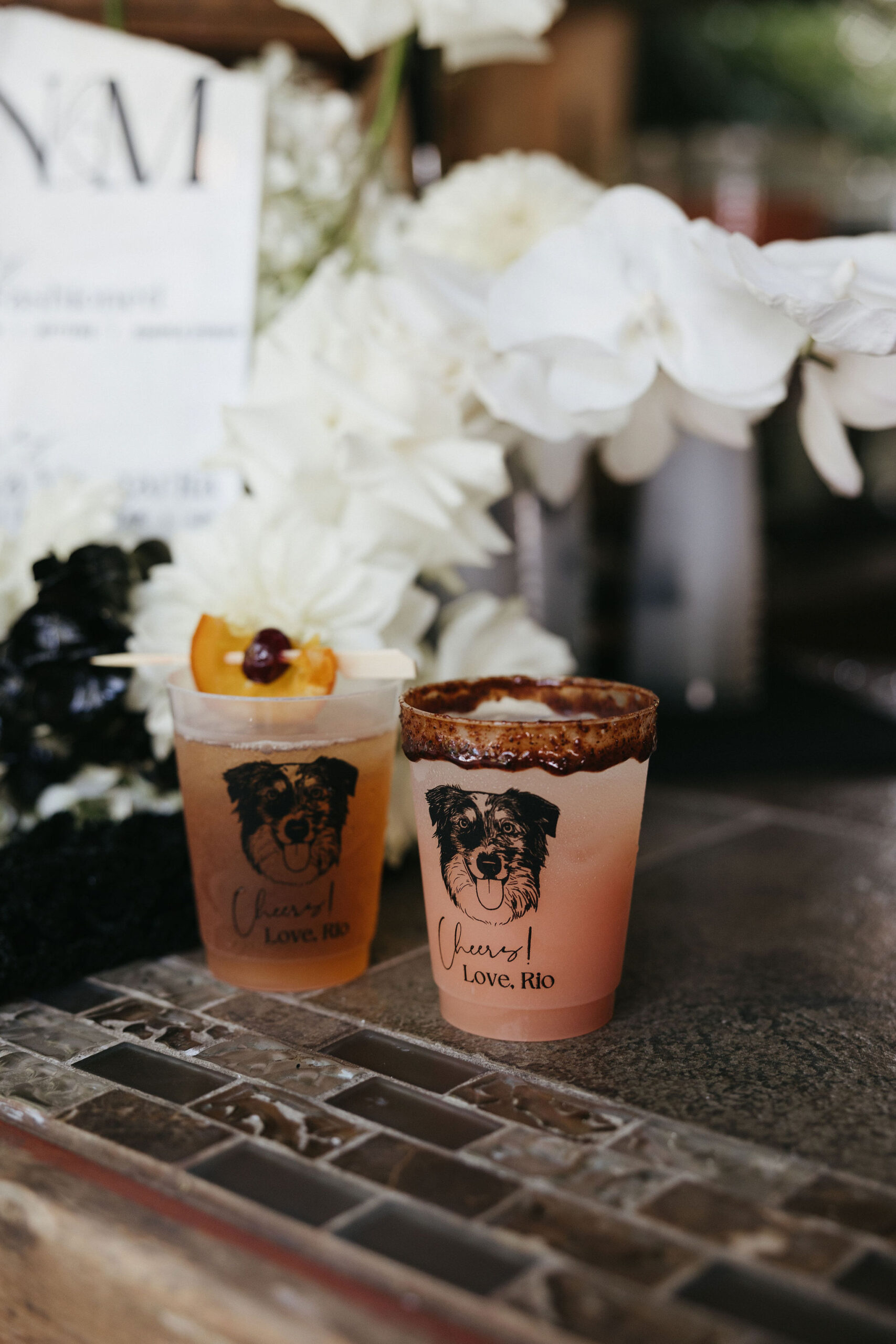 Signature wedding cocktails with dog faces on the cups 