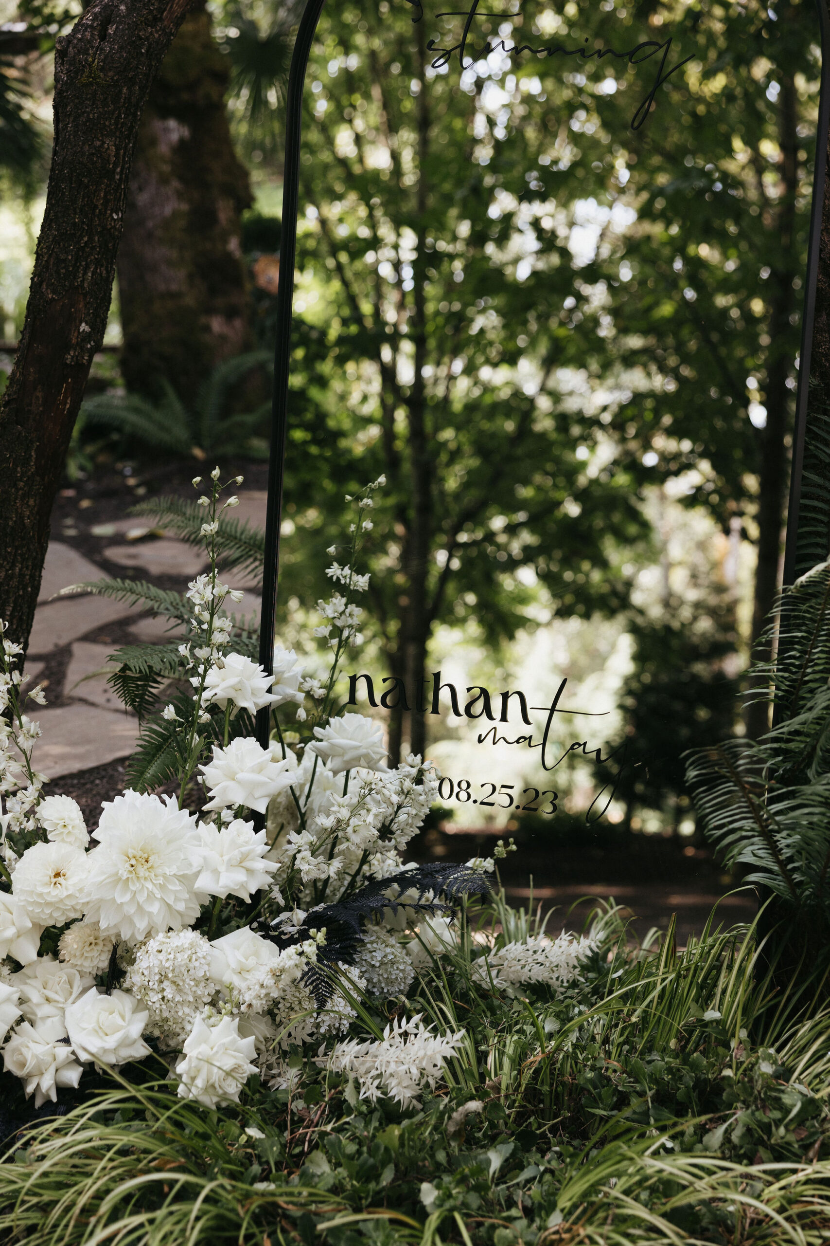 DIY'd wedding welcome sign with white roses and florals