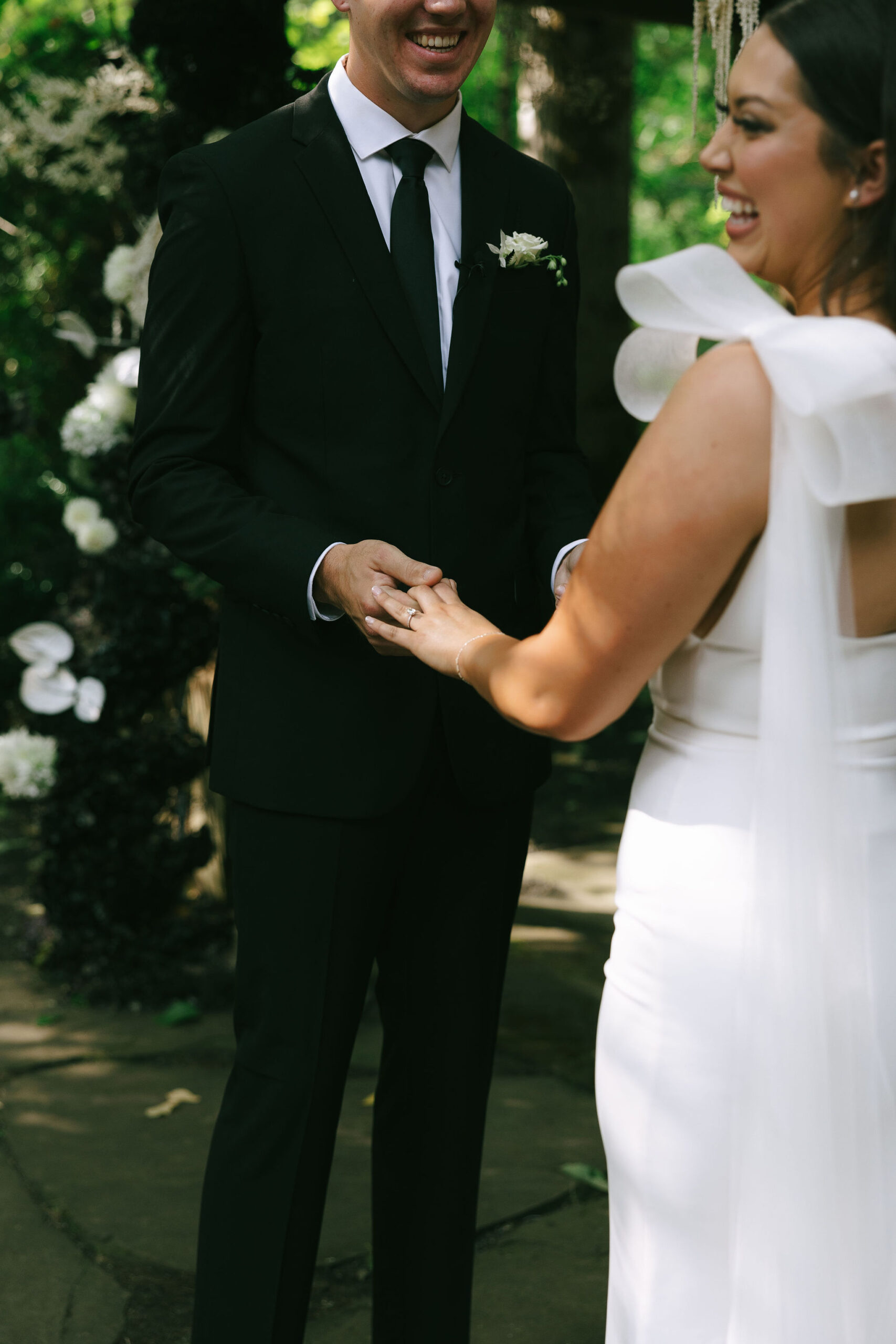 Bride and grooms smiling holding hands during their Maroni Meadows wedding ceremony