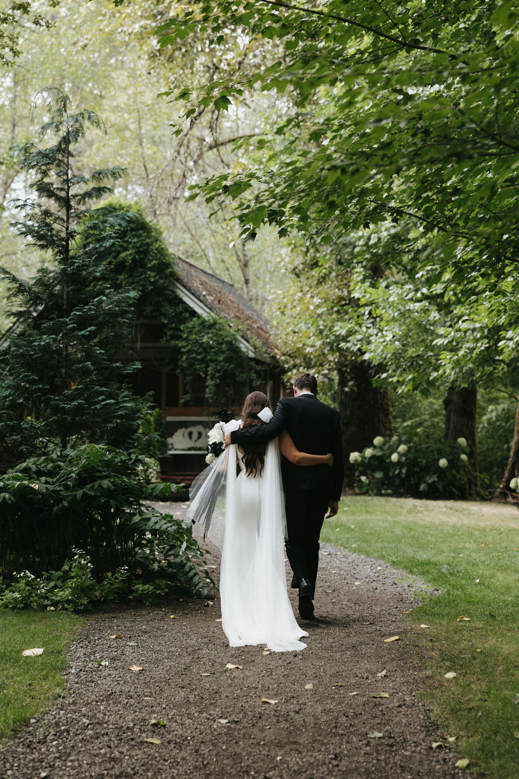 Bride and groom holding eachother walking off into the distance at Maroni meadows wedding venue