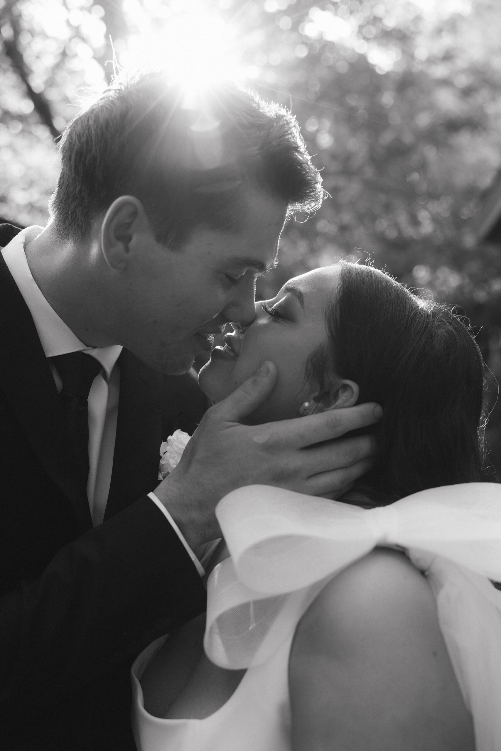 Black and white photo of bride and groom about to kiss