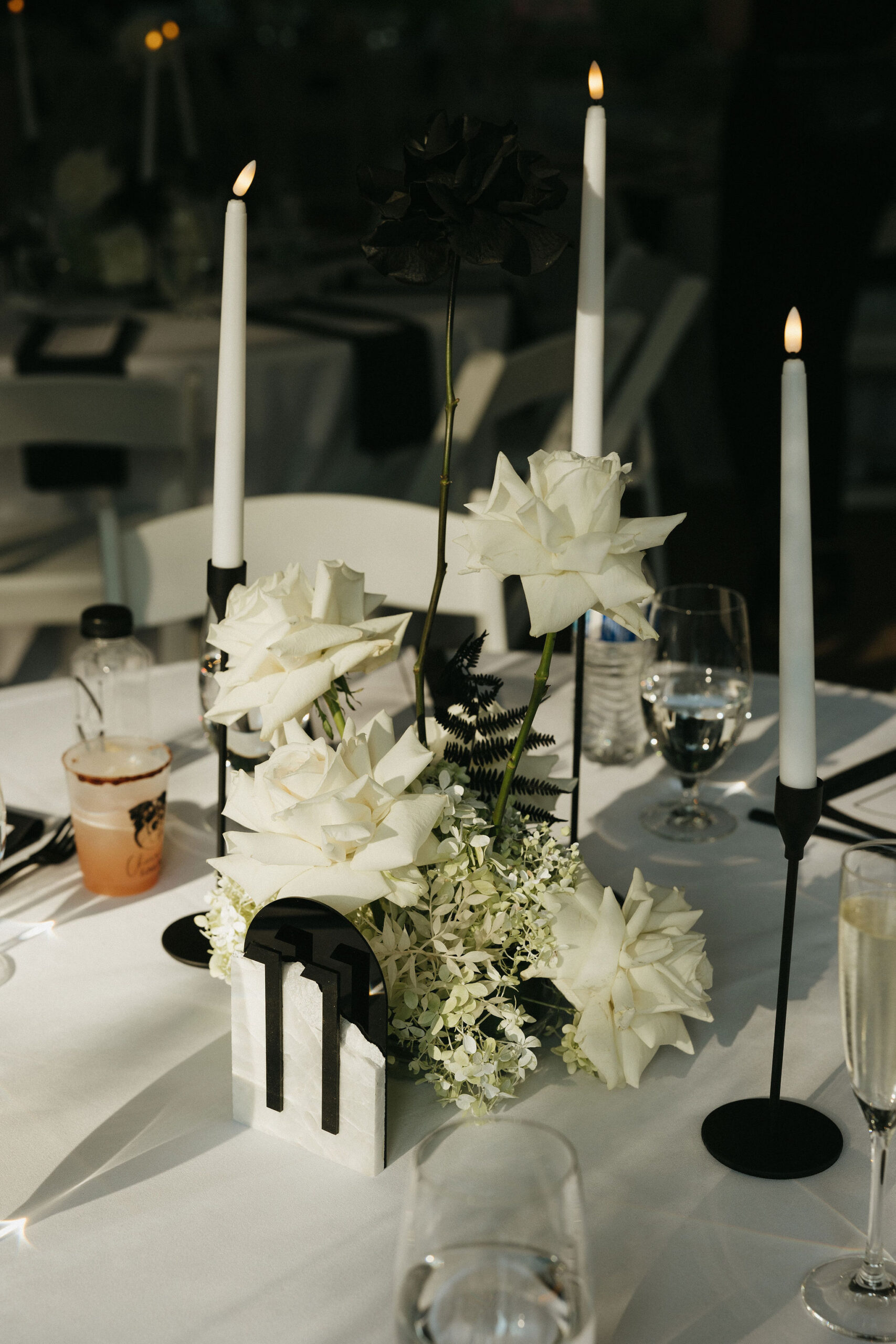 Wedding reception tablescapes with white florals and black details