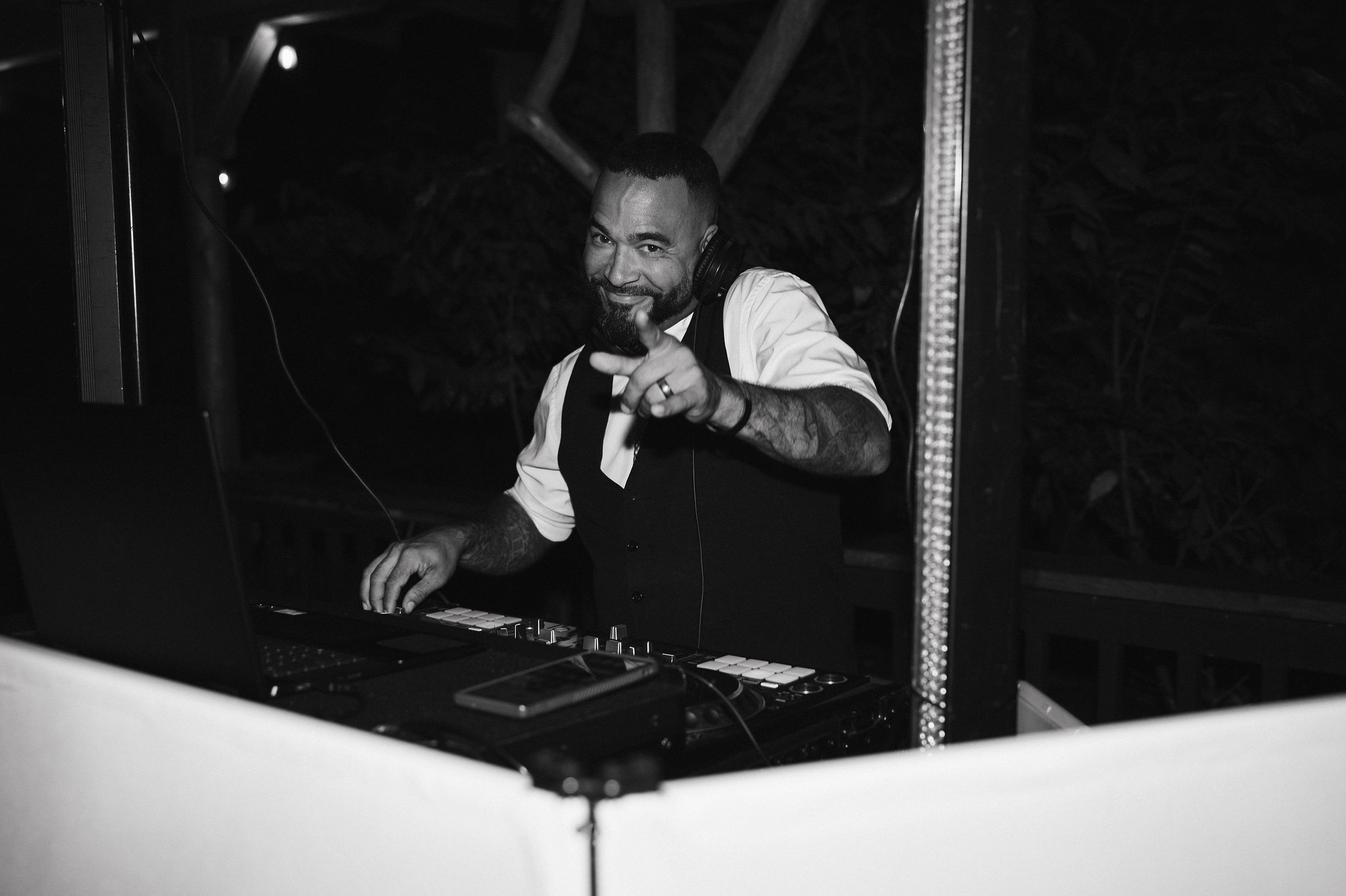 Black and white photo of dj playing at the wedding reception 