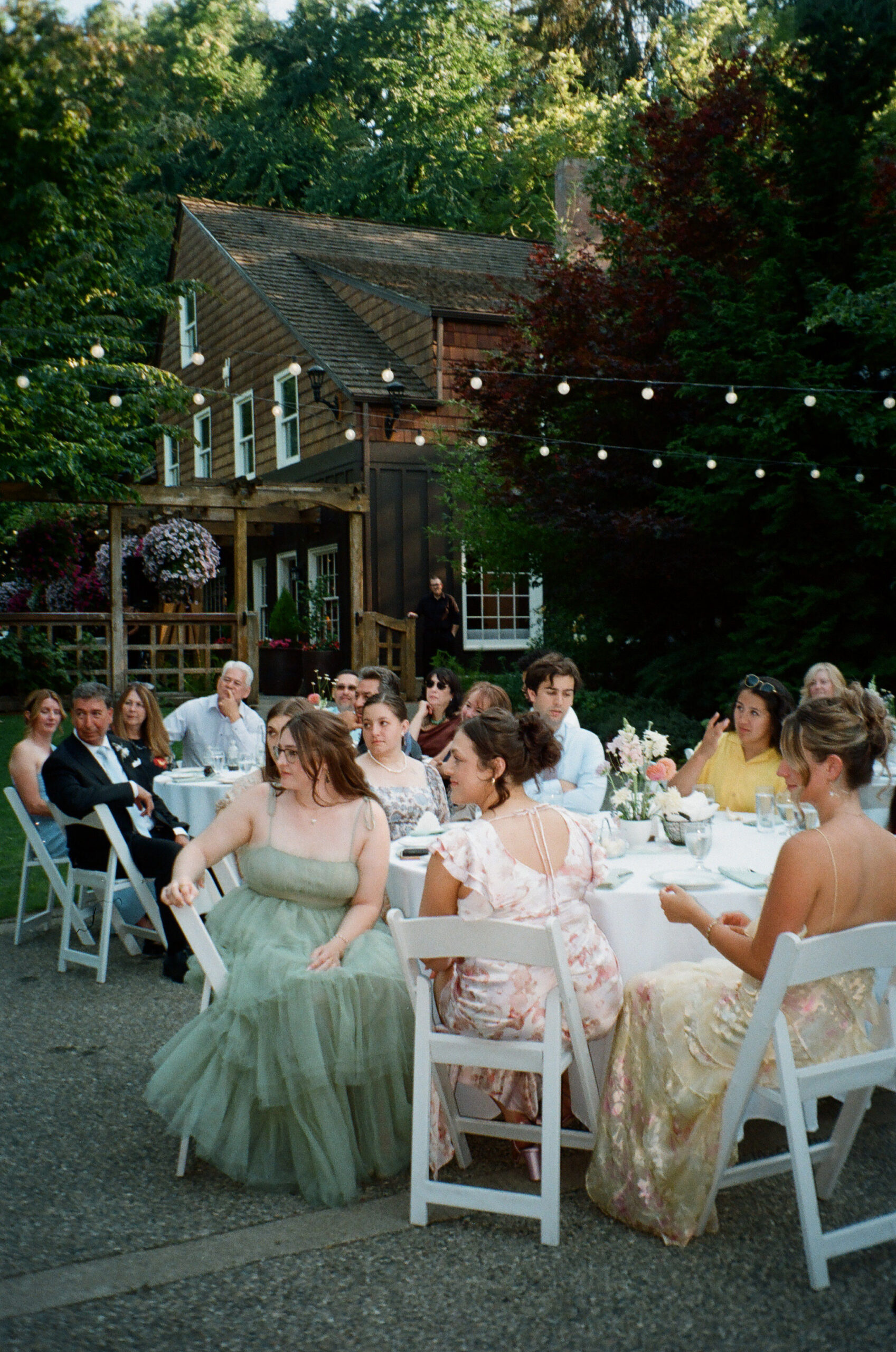 Film photo of guests sitting at their tables during the wedding reception at Robinswood House