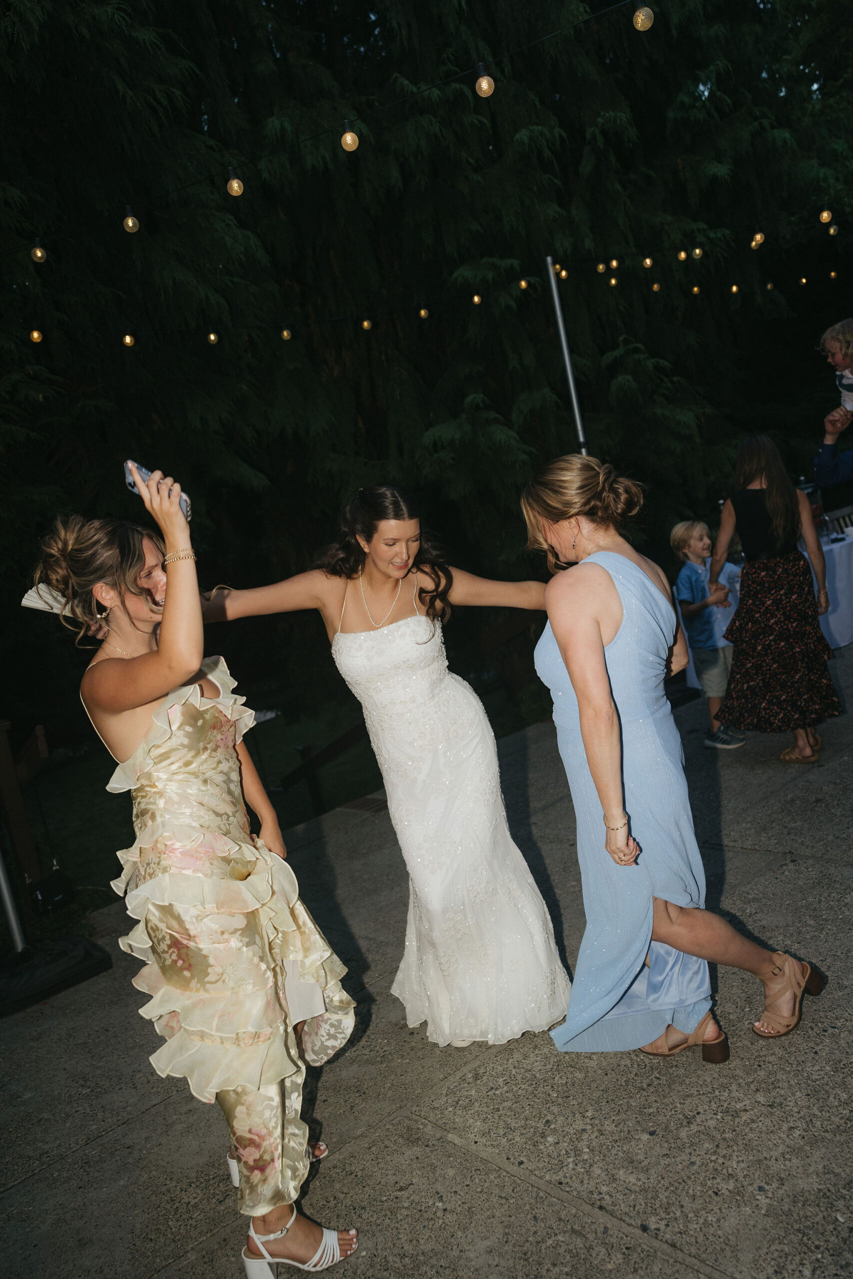 Bride dancing with guests at her wedding reception