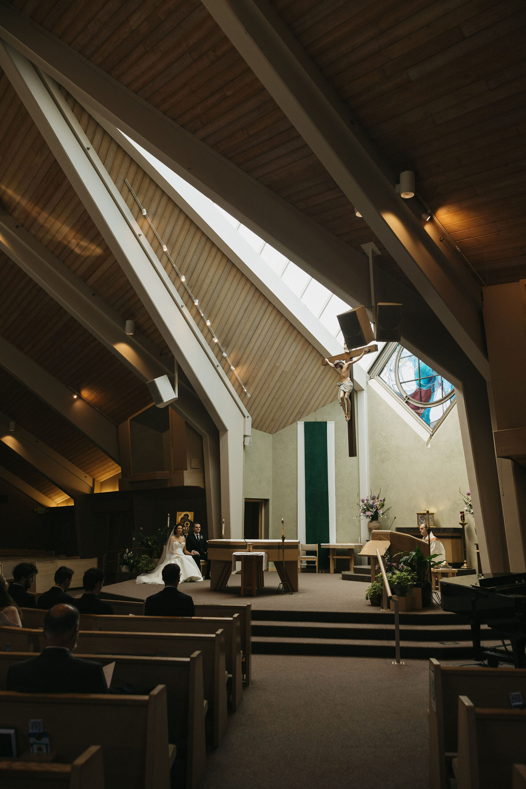 Bride and groom having their wedding ceremony at the Holy Family Catholic Church