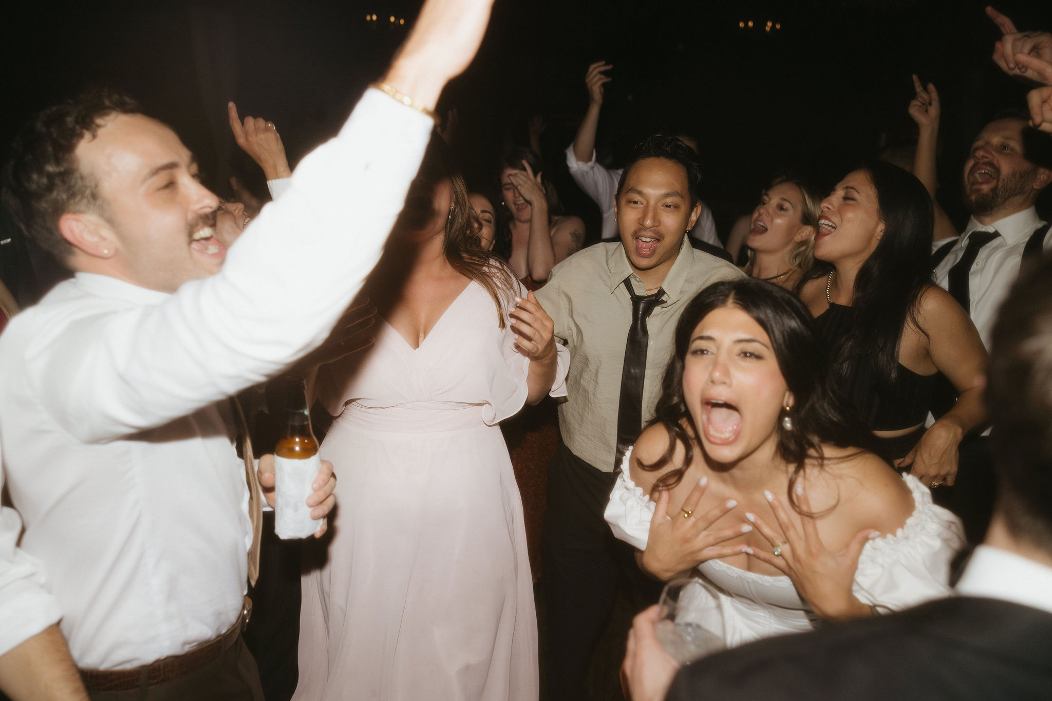 A fun moment on the dance floor where guests are singing and having a great time, capturing the lively atmosphere of the Greenpoint Loft Wedding.