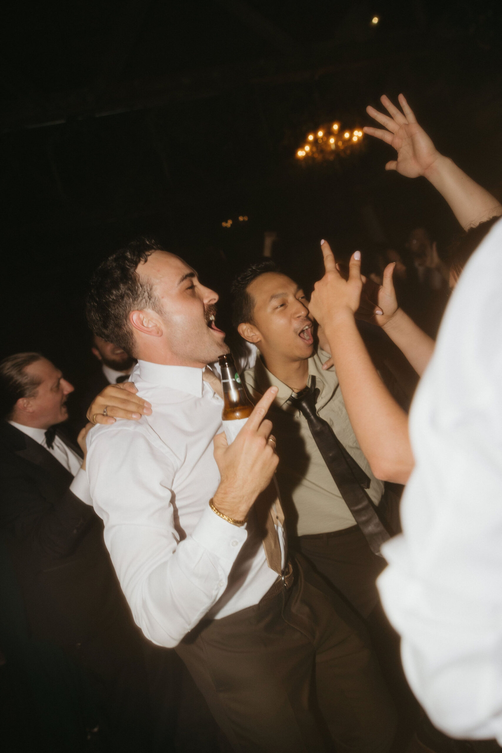 A fun moment on the dance floor where guests are singing and having a great time, capturing the lively atmosphere of the Greenpoint Loft Wedding.