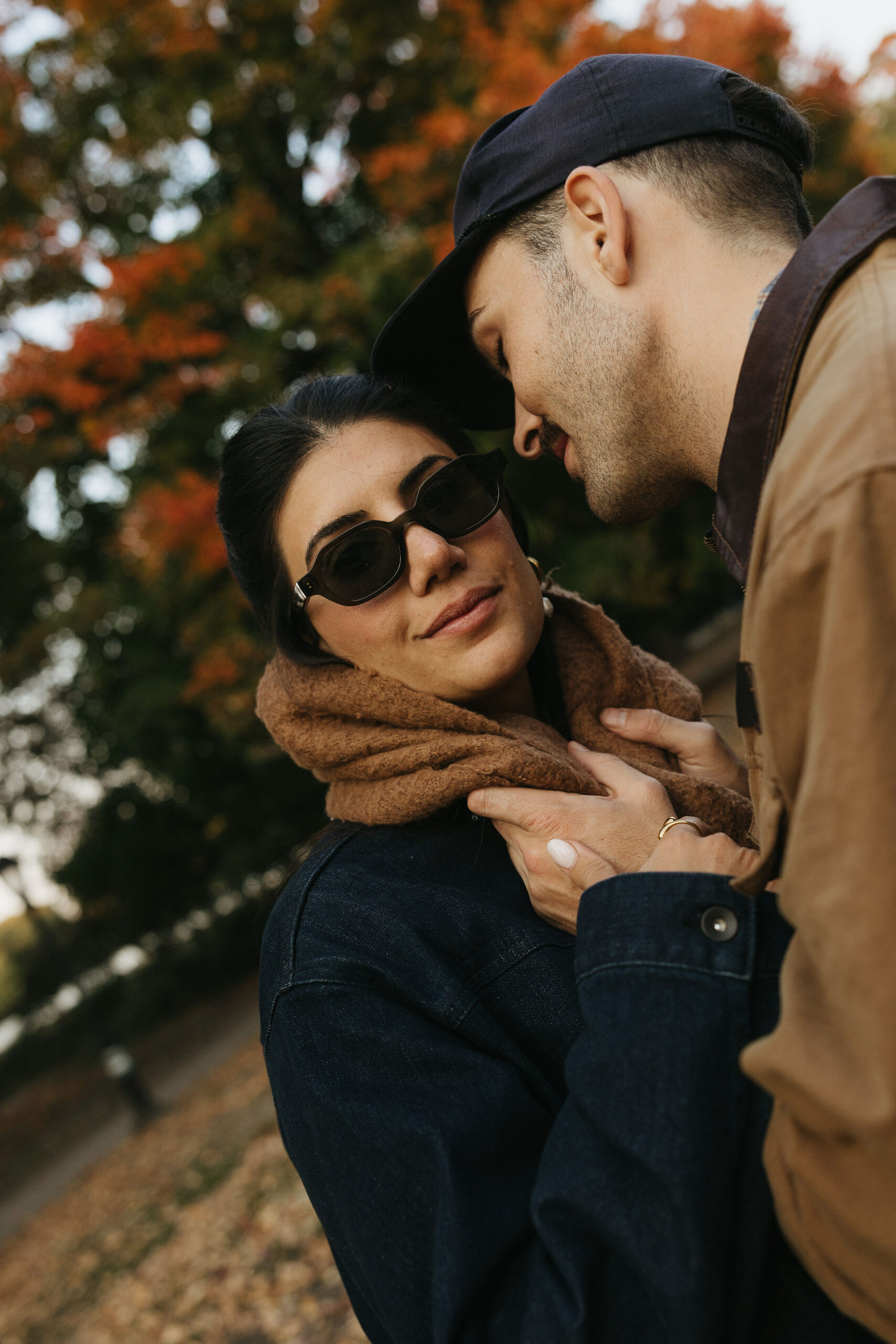 Couple holding eachother as soon to be husband goes in for a kiss