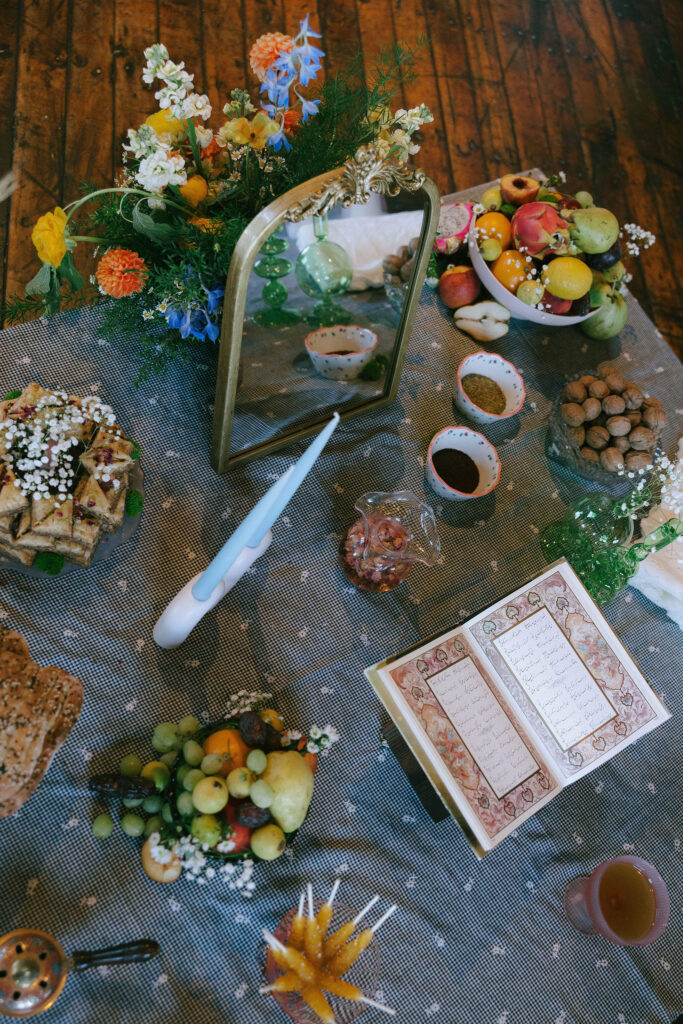 Colorful spread of fruits, nuts, and decor on a table, part of a Greenpoint Loft Wedding tradition.